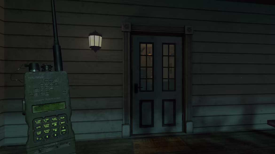 A handheld paranormal radio in front of the estate entrance.