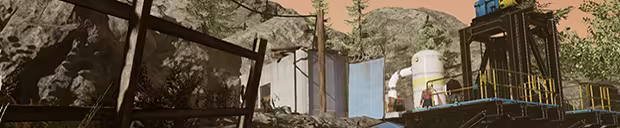 An exterior view of a rustic facility built into a rocky hillside under an orange sky. A wooden fence is in the foreground, with a metal elevator and small buildings further up the hill.