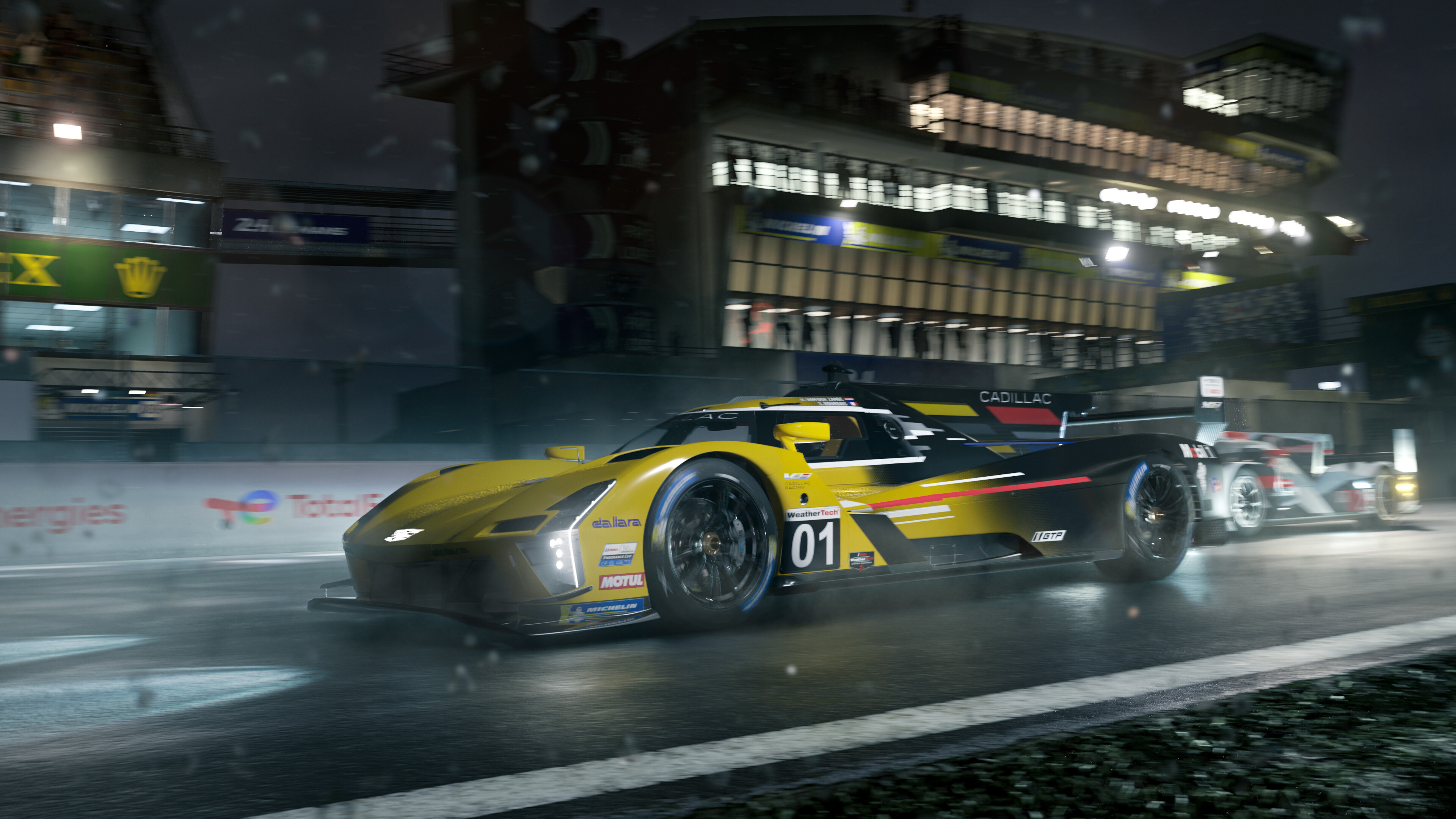 Cadillac prototype race car speeds through the pit lane on a rainy night track
