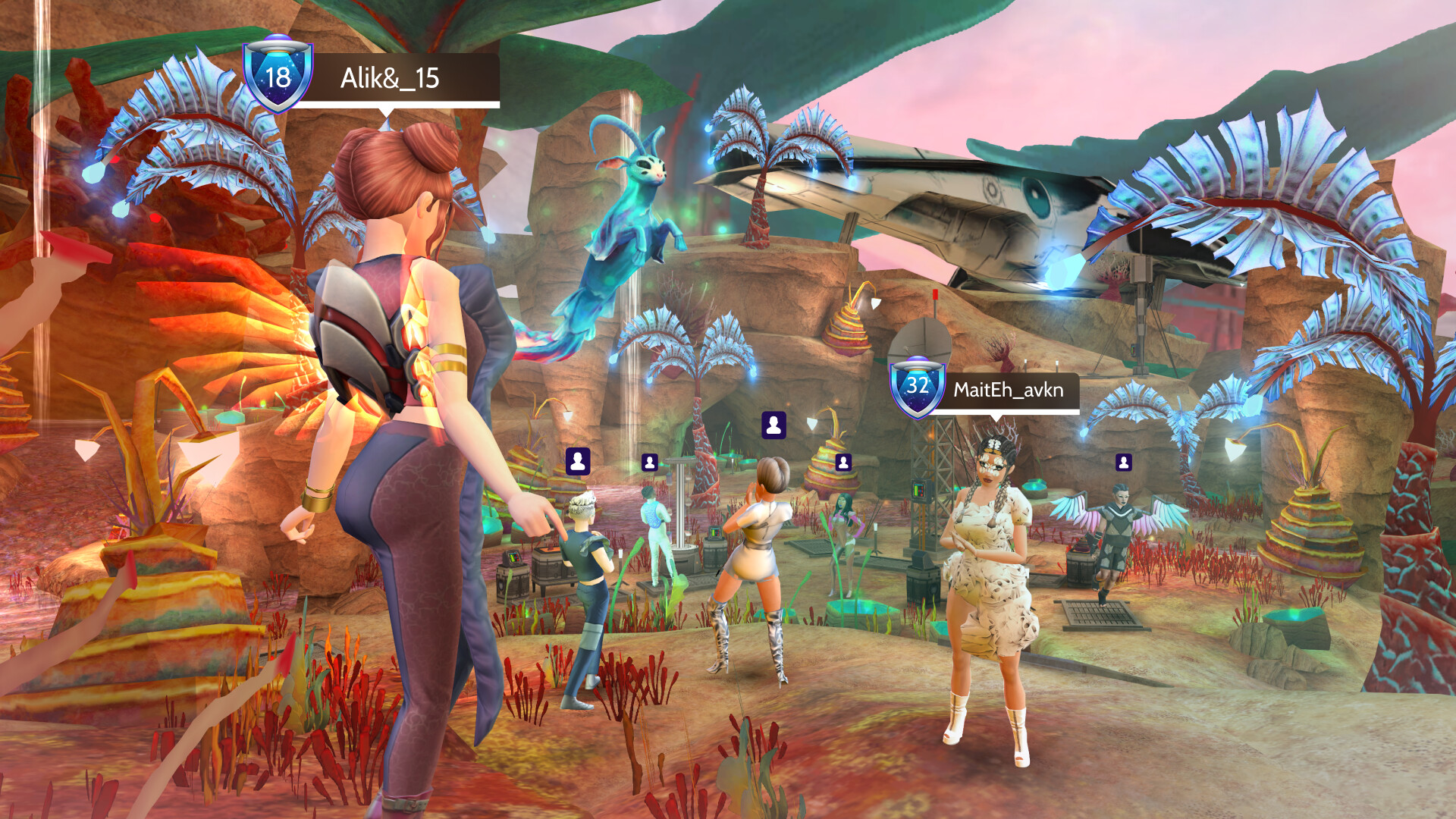 The image depicts a vibrant virtual environment with several animated characters interacting in a colorful, alien-like landscape. The scene features rocky terrain with glowing blue and purple bioluminescent plants and futuristic structures scattered around. Two prominent avatars stand in the foreground: one with orange wings and a tight outfit labeled 'Alik&_15' with a shield icon and level 18, and another in a floral dress with a headpiece and white boots labeled 'MaitEh_avkn' with a shield icon and level 32. Other characters can be seen engaging in various poses, and a small blue, glowing creature floats nearby, adding to the fantastical atmosphere.