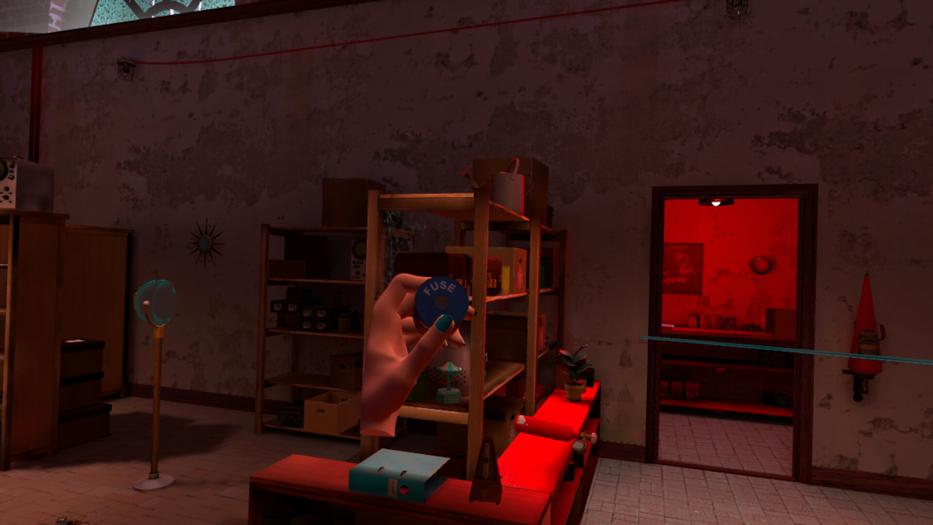 A player holds a fuse in Amelia's Escape, with a red-lit doorway leading to another part of the workshop
