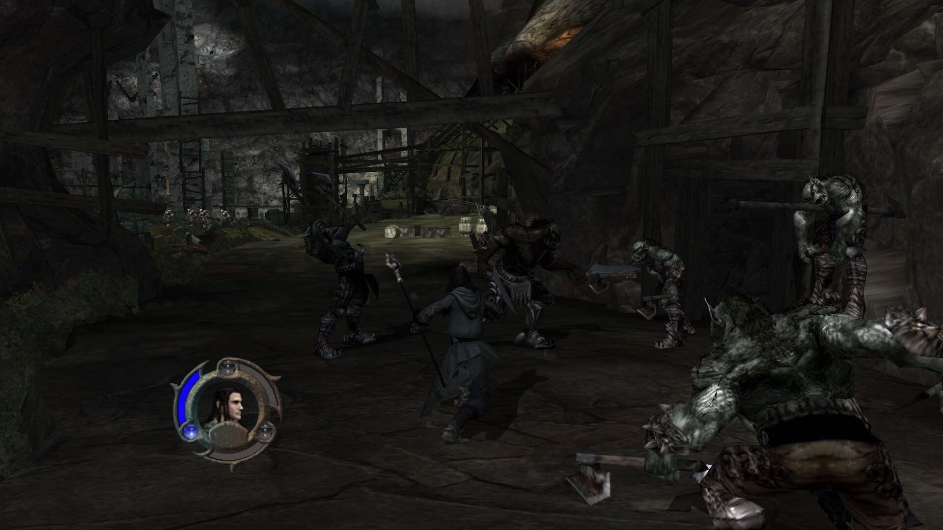 The scene depicts a dark, cavernous environment with rocky walls and wooden beams creating a partially enclosed space. In the center, a character clad in a long cloak and holding a staff or spear is facing off against a group of large, monstrous creatures with greyish skin, muscular builds, and menacing weapons like axes and clubs. The creatures appear aggressive, surrounding the lone figure, who seems prepared for combat. The atmosphere is dimly lit, adding to the tension and sense of danger in this underground confrontation.