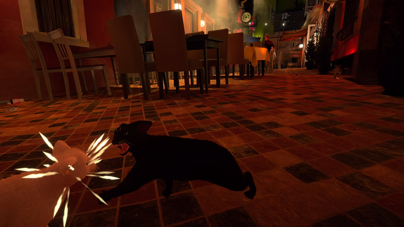 A black cat swipes a white rival with its paw in a nighttime cafe lane.