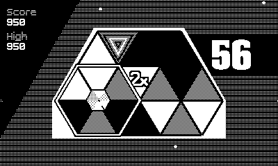 Gameplay footage of HEXA. A six-sided cursor navigates around a grid of 19 triangles, rotating them to try and create a full hexagon of same-colored triangles. When this happens, the word "HEXA" appears on-screen with a bombastic flashing effect.