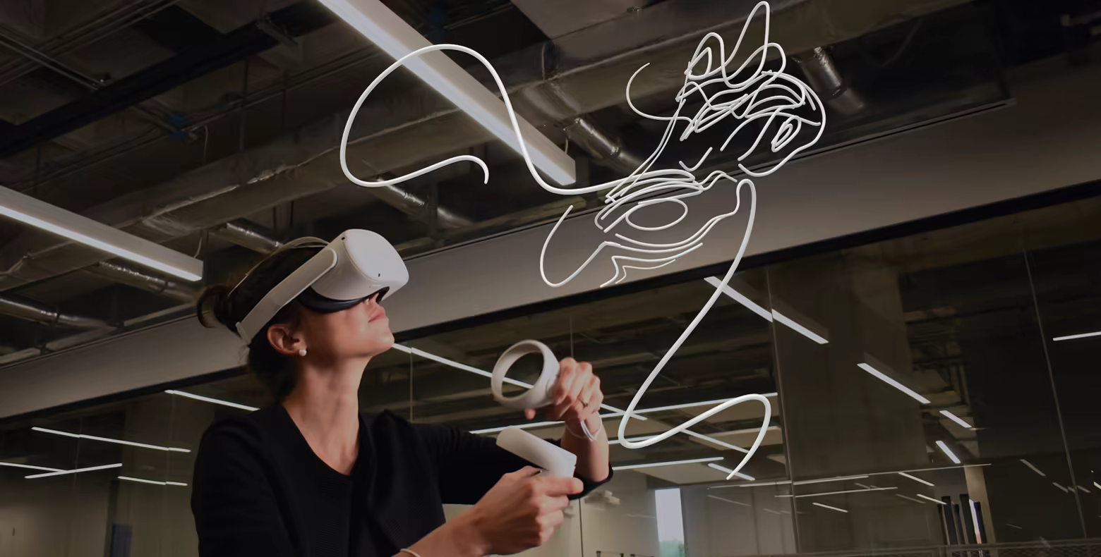 Person using a VR headset and controllers to draw 3D lines